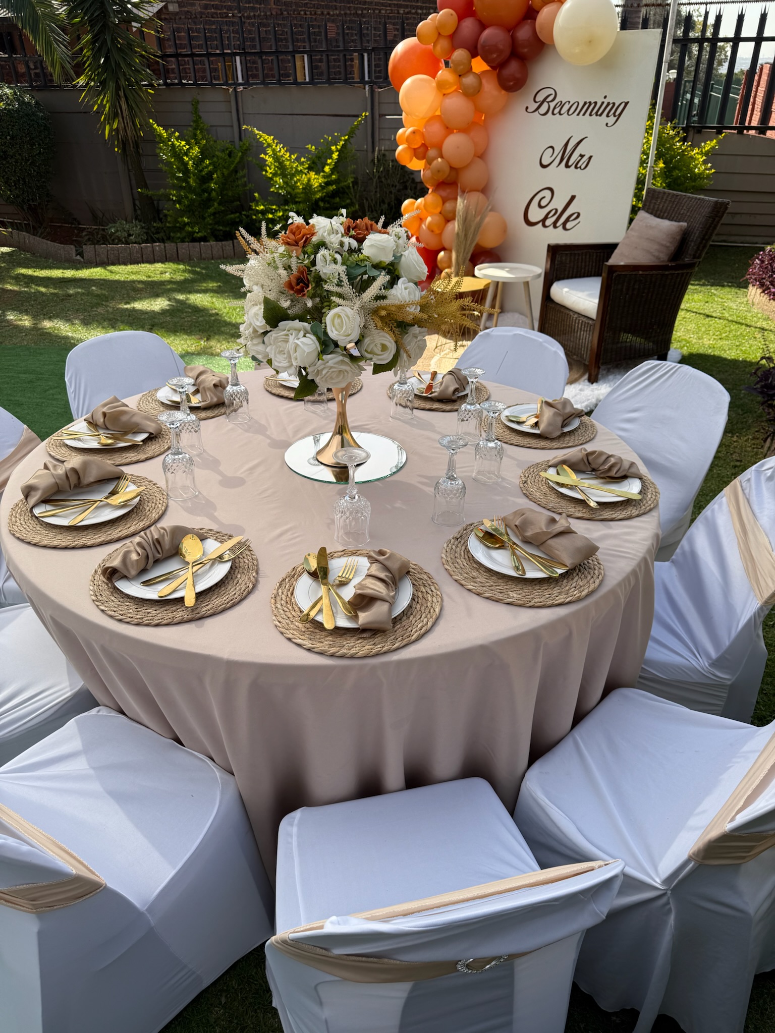 Elegant outdoor reception table with neutral linens and candle arrangements
